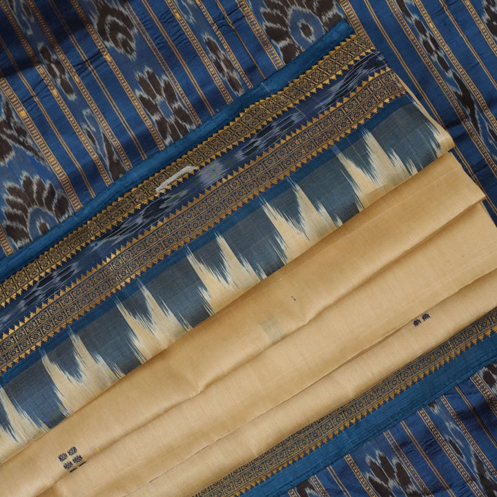 Elegant styling of cream and blue Khandua silk saree with butta pattern on model for traditional look