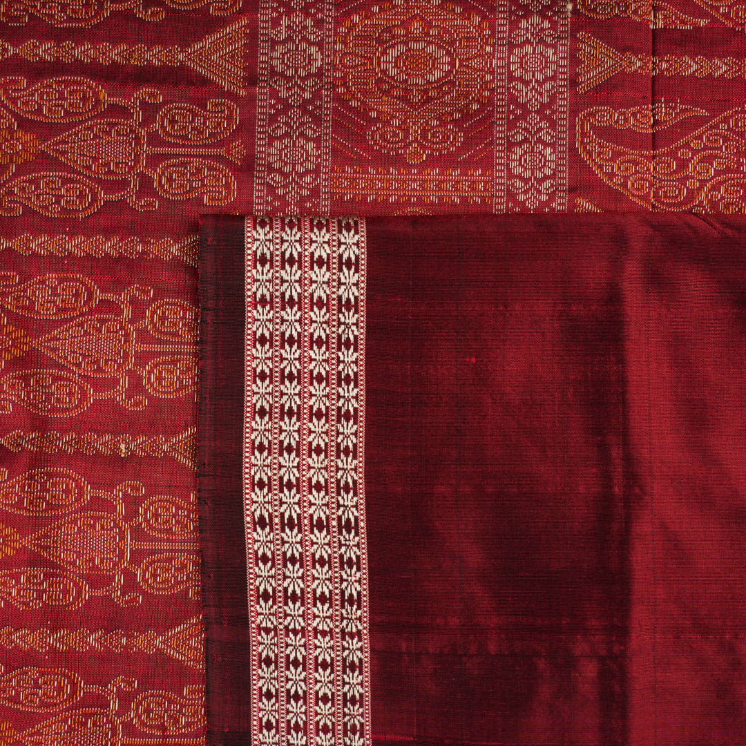 Close-up of Bomkai Silk Saree fabric, highlighting its luxurious brown silk texture and intricate weave.
