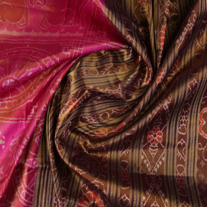 Close-up of Sambalpuri silk fabric texture, highlighting the fine weave in pink and maroon with delicate tissue motifs.