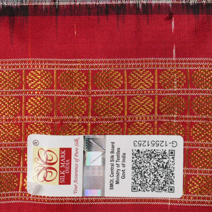 Close-up of Sambalpuri silk saree fabric, revealing rich texture, weave, and subtle tissue motifs.