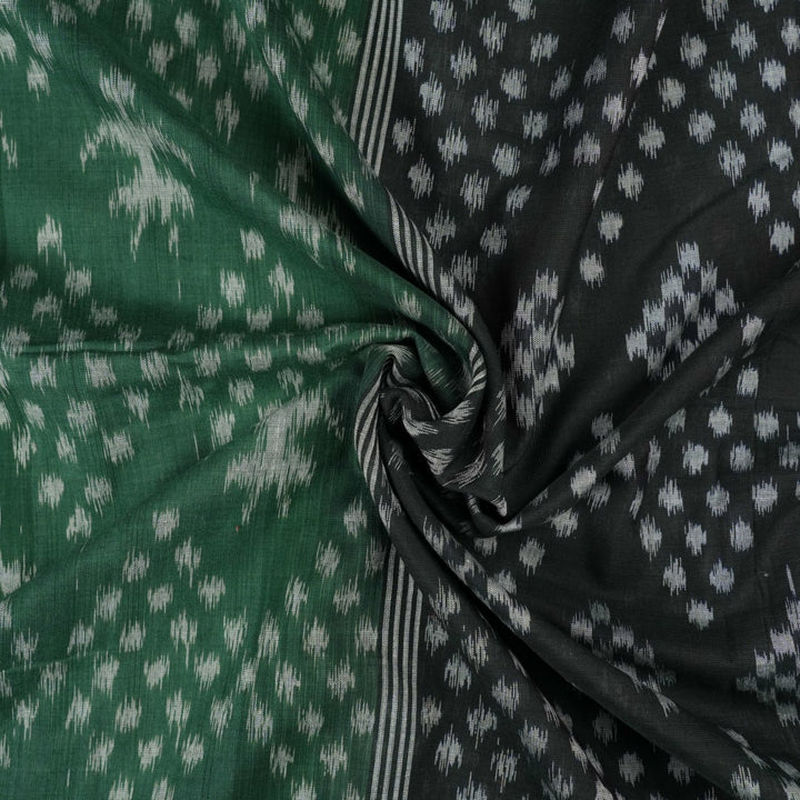 Elegant model draping a green and black Sambalpuri cotton saree with traditional Odisha handloom motifs.