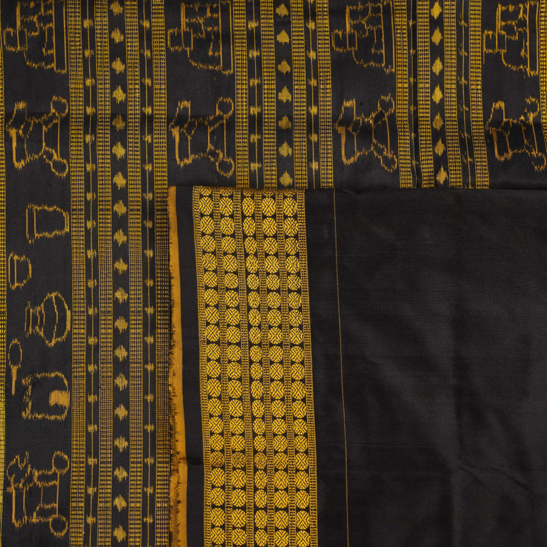 Close-up of the black Sambalpuri silk saree fabric, revealing its rich texture and the intricate weave of the motifs.