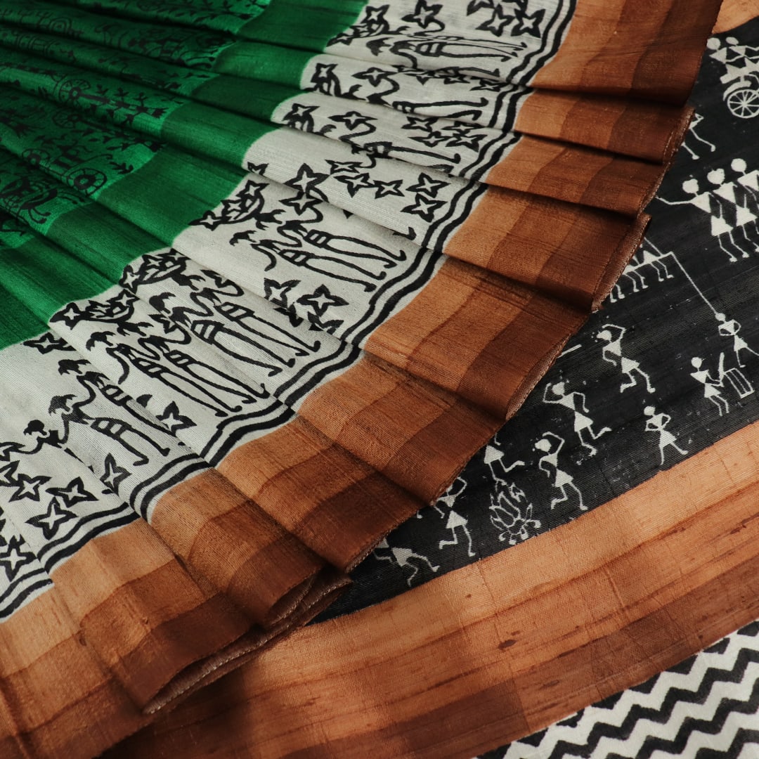 Full view of a green and brown Tussar silk saree featuring traditional motifs throughout the body.