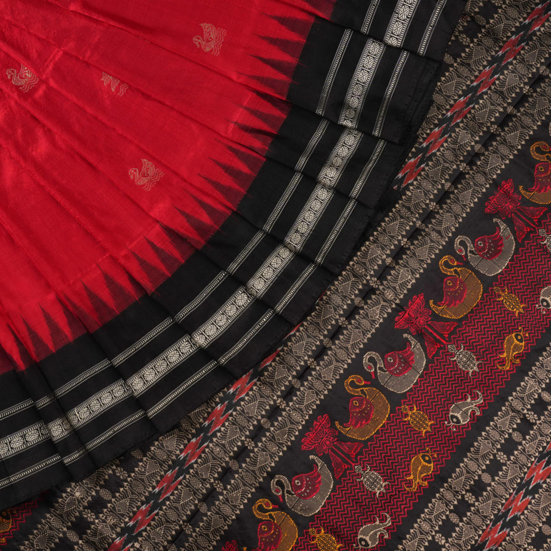 Extreme close-up revealing the fine handloom texture and intricate weave of the Bomkai silk fabric.