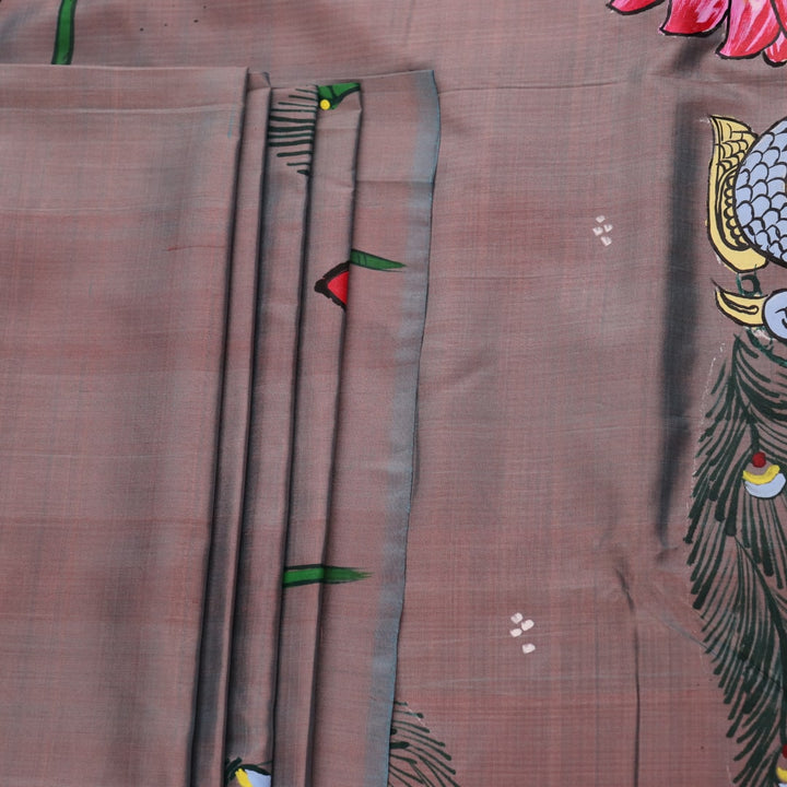 Close-up of hand-painted silk Patachitra saree fabric texture, showing the multicolor details and fine weave.