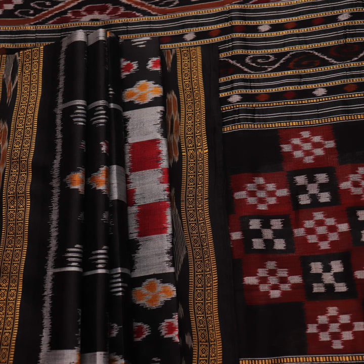 A woman elegantly draping a black silk Khandua Pasapalli saree with a detailed view of the drape and fall of the fabric.