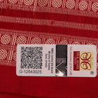 Close-up of grey and red Sambalpuri silk saree fabric showing intricate woven motif texture.