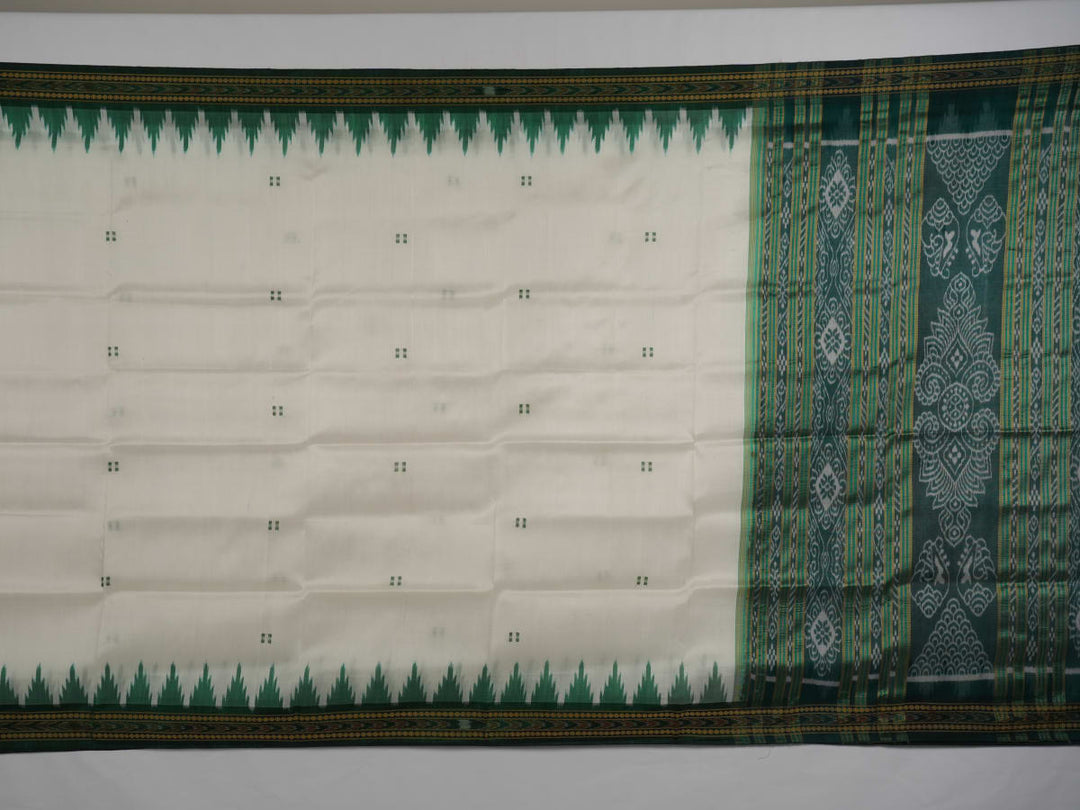 Model wearing a white Khandua silk saree with green butta and border, showcasing a graceful drape.