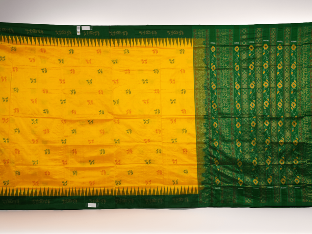 Extreme close-up of yellow Bomkai Silk Saree fabric, revealing the rich silk texture and weave.