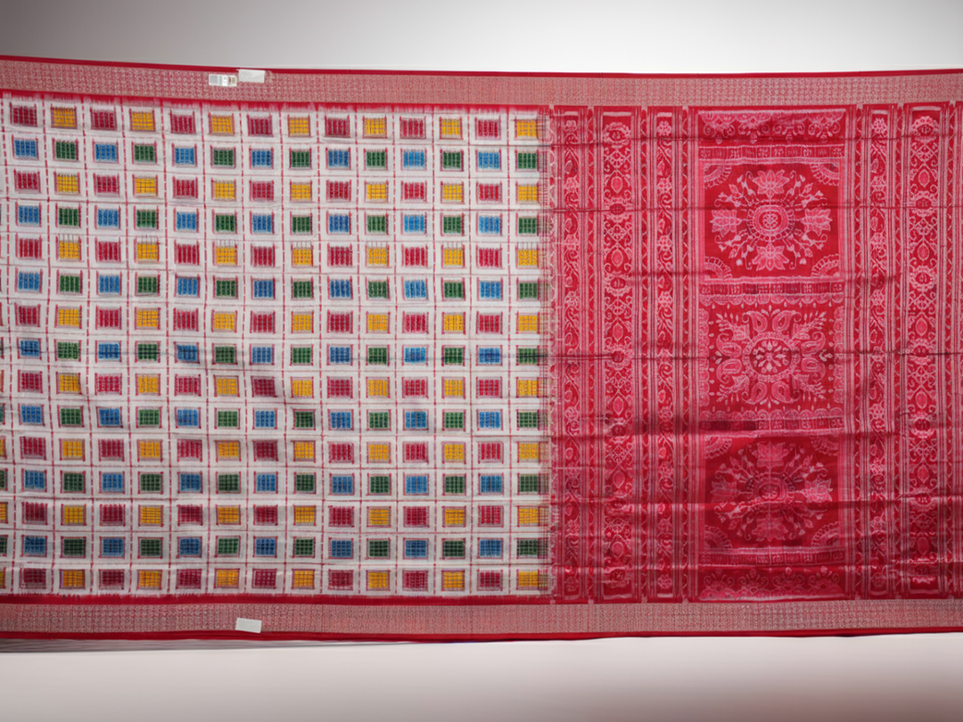 Close-up of the luxurious white Sambalpuri silk saree fabric, highlighting its rich texture and weave.