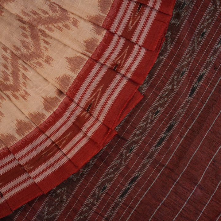 Traditional styling of a cream and rust Sambalpuri cotton saree draped on a model for a classic look.