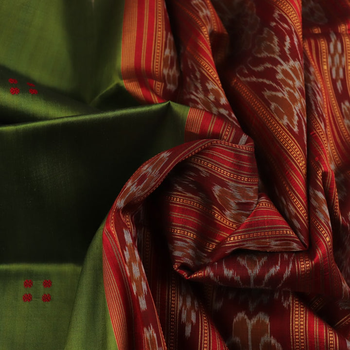 Green Khandua silk saree draped, showcasing its butta pattern and red accents.