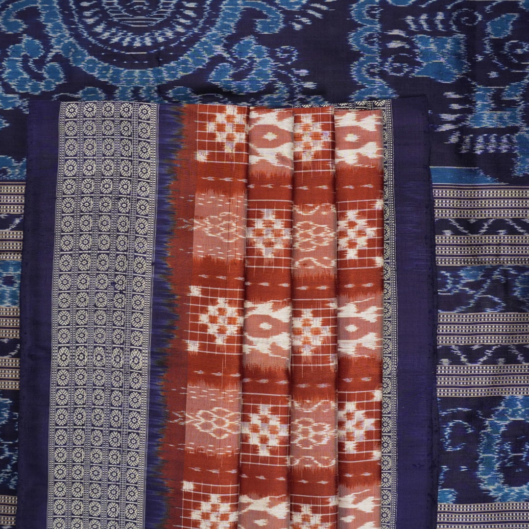 Close-up of the rich silk fabric texture of the Sambalpuri Saree, showing the intricate weave and slight sheen.