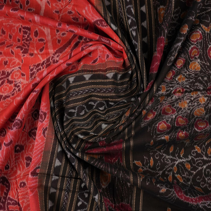 Full layout view of a rust and black Sambalpuri cotton saree displaying the complete body pattern and motifs.