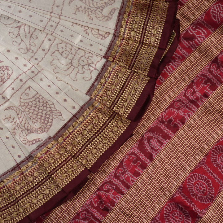 Close-up of the fine silk texture of the white Sambalpuri saree, highlighting its soft sheen and weave.