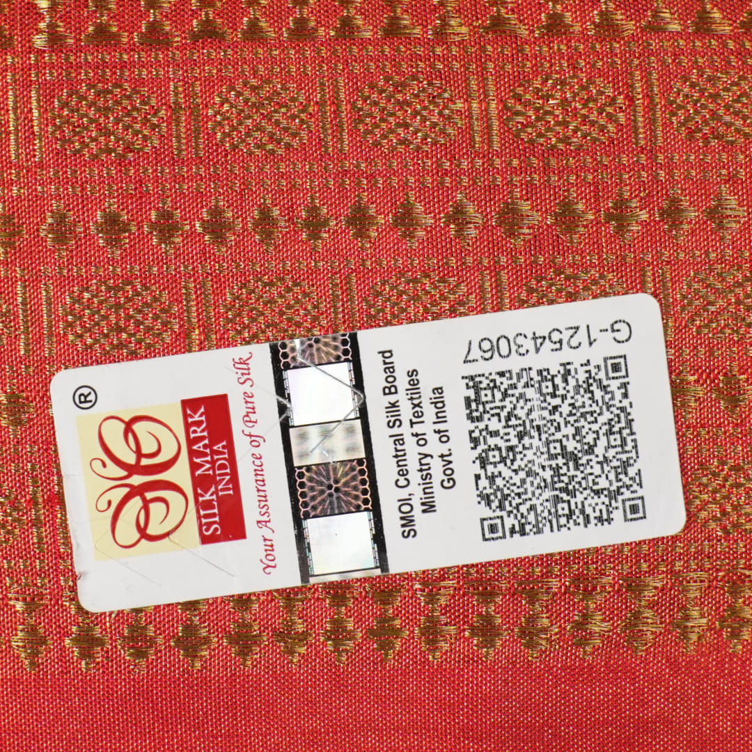 Close-up of rust Sambalpuri silk fabric, revealing its luxurious texture and fine handloom weave.