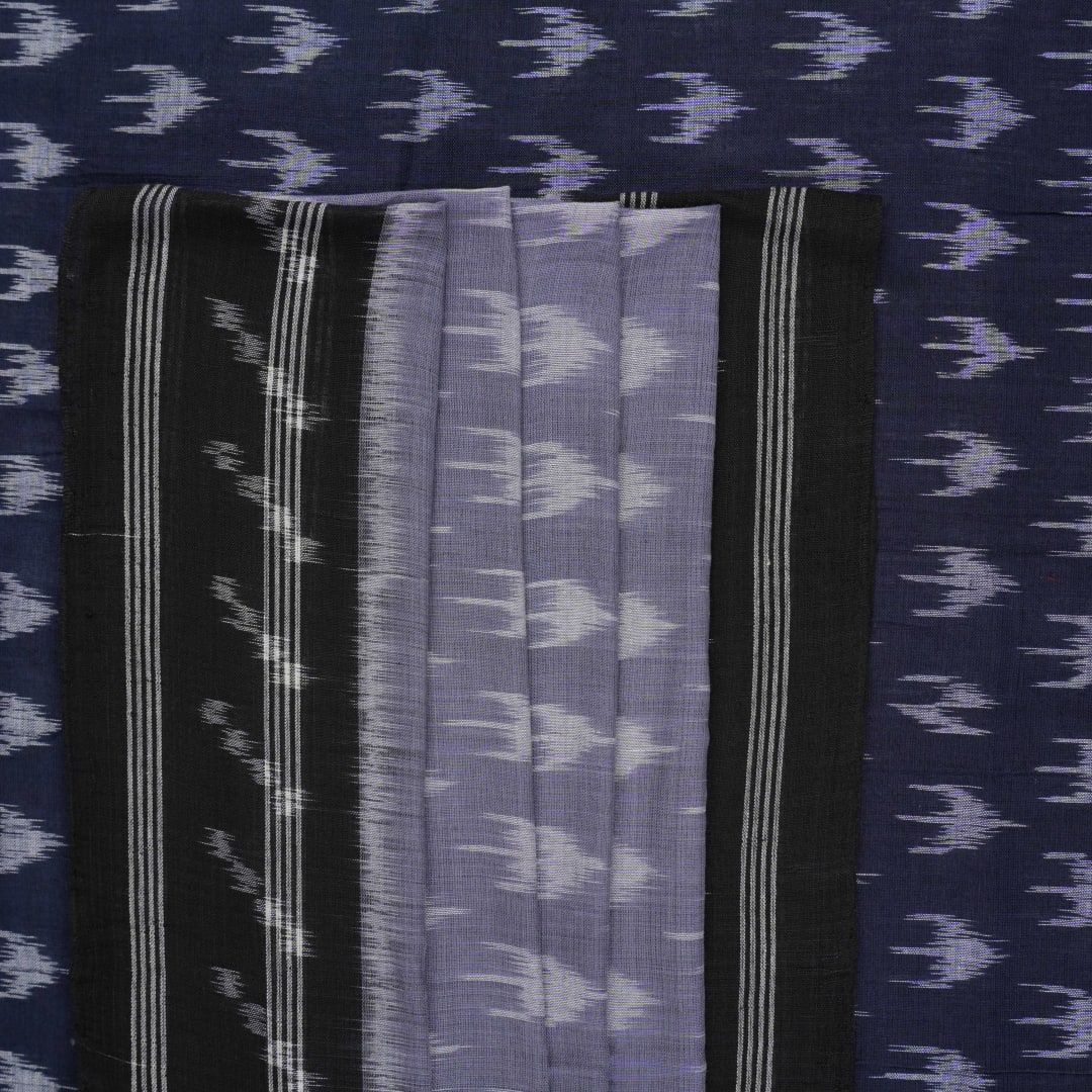 Model wearing a grey and black Sambalpuri cotton saree with traditional ikat motifs in a classic ethnic drape.