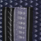 Model wearing a grey and black Sambalpuri cotton saree with traditional ikat motifs in a classic ethnic drape.