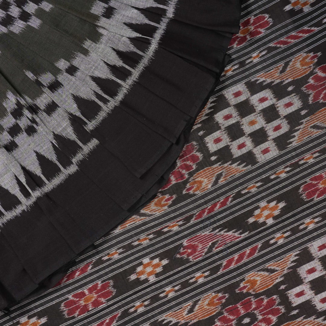 Model wearing a stylish green and black Sambalpuri cotton saree with traditional handloom woven motifs