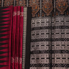 Close-up of magenta and black Bomkai silk saree texture, showing butta pattern weave.