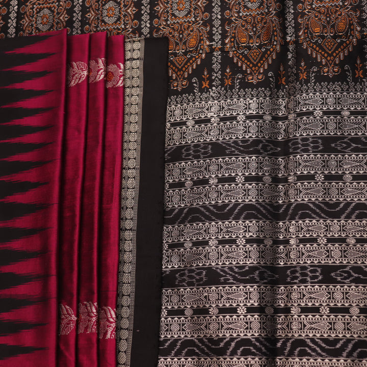 Close-up of magenta and black Bomkai silk saree texture, showing butta pattern weave.