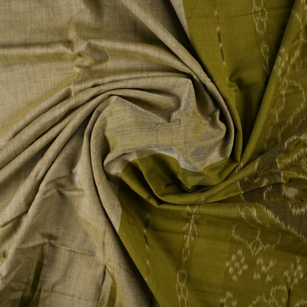 Full styling view of a model draped in a plain green Sambalpuri cotton saree with traditional accents.