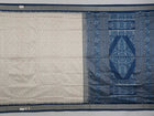 Close-up of premium fabric texture and handloom weave on a white and blue Sambalpuri silk saree