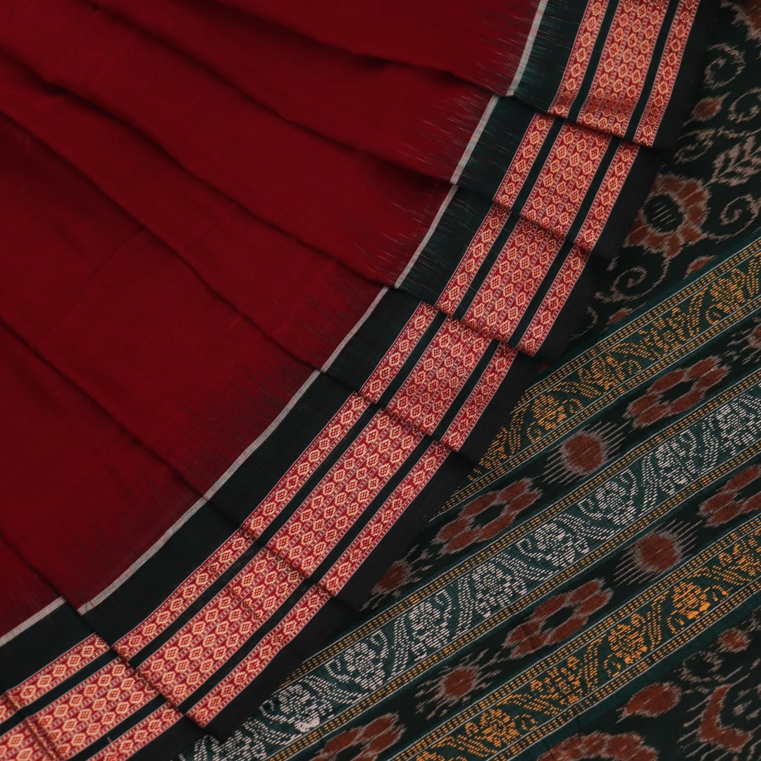 Full view of a maroon cotton Bomkai saree with green butta pattern throughout.