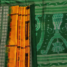 Close-up of yellow Sambalpuri silk saree fabric showing intricate motifs and woven texture.