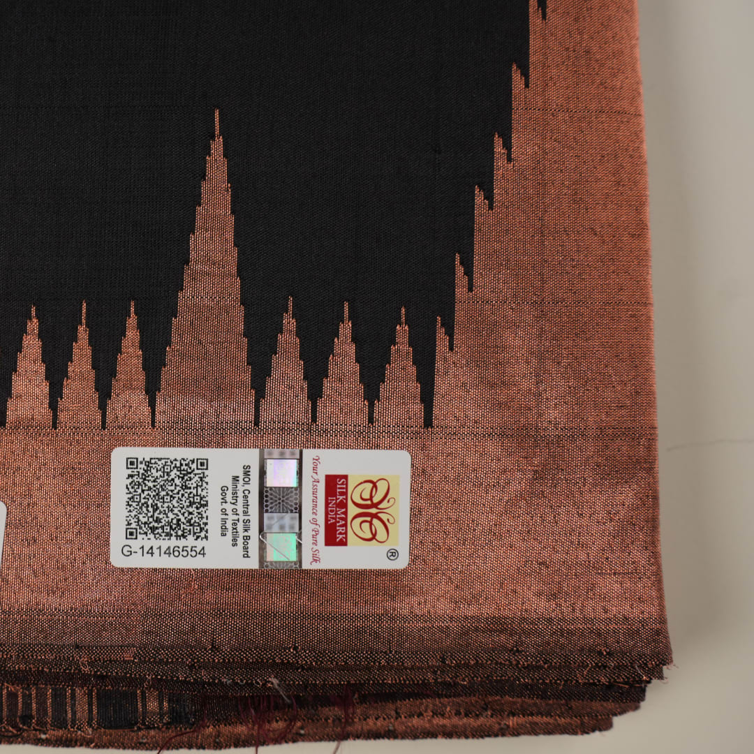 Extreme close-up showing the rich black and brown Sambalpuri Silk fabric texture and intricate handloom weave.