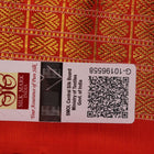 Close-up of maroon and orange Sambalpuri silk saree fabric texture, showcasing handloom weave and motif details.