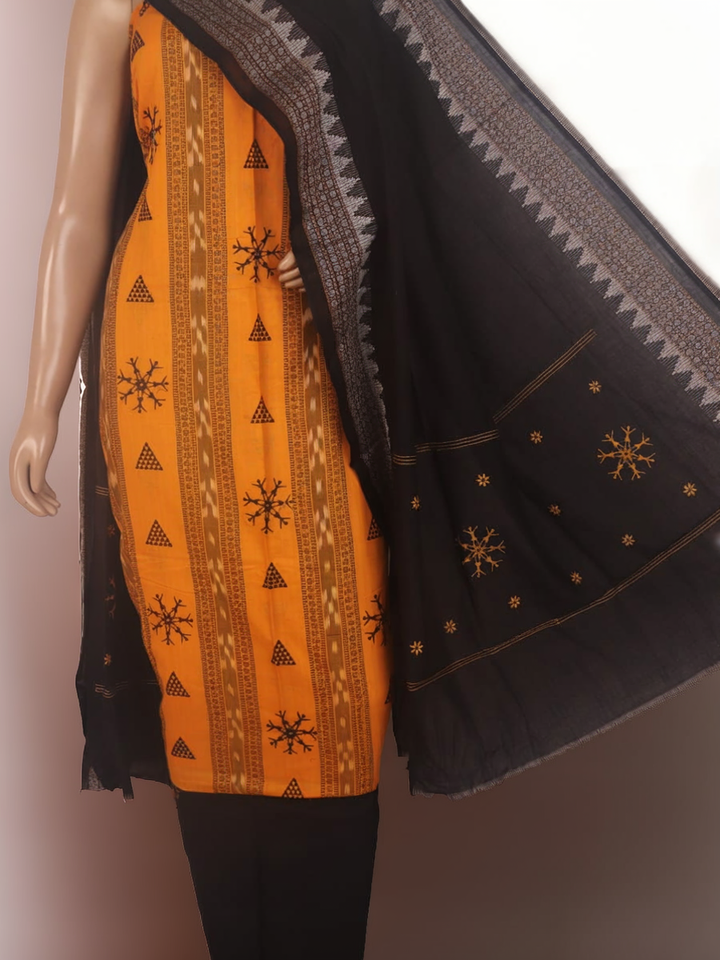 Close-up of yellow and black Sambalpuri cotton dress material blouse piece with motifs.