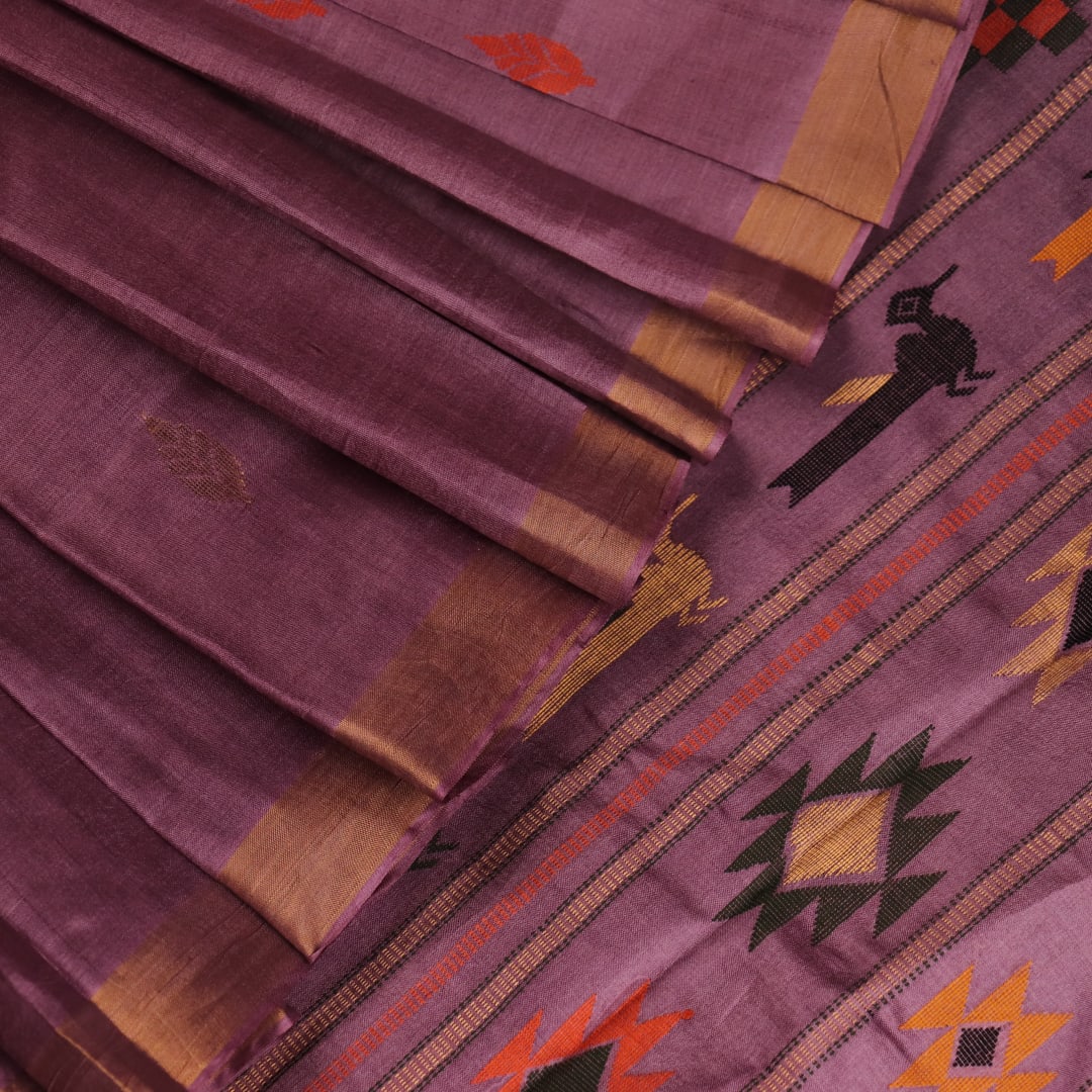 Close-up view of the textured Tussar silk fabric of the saree