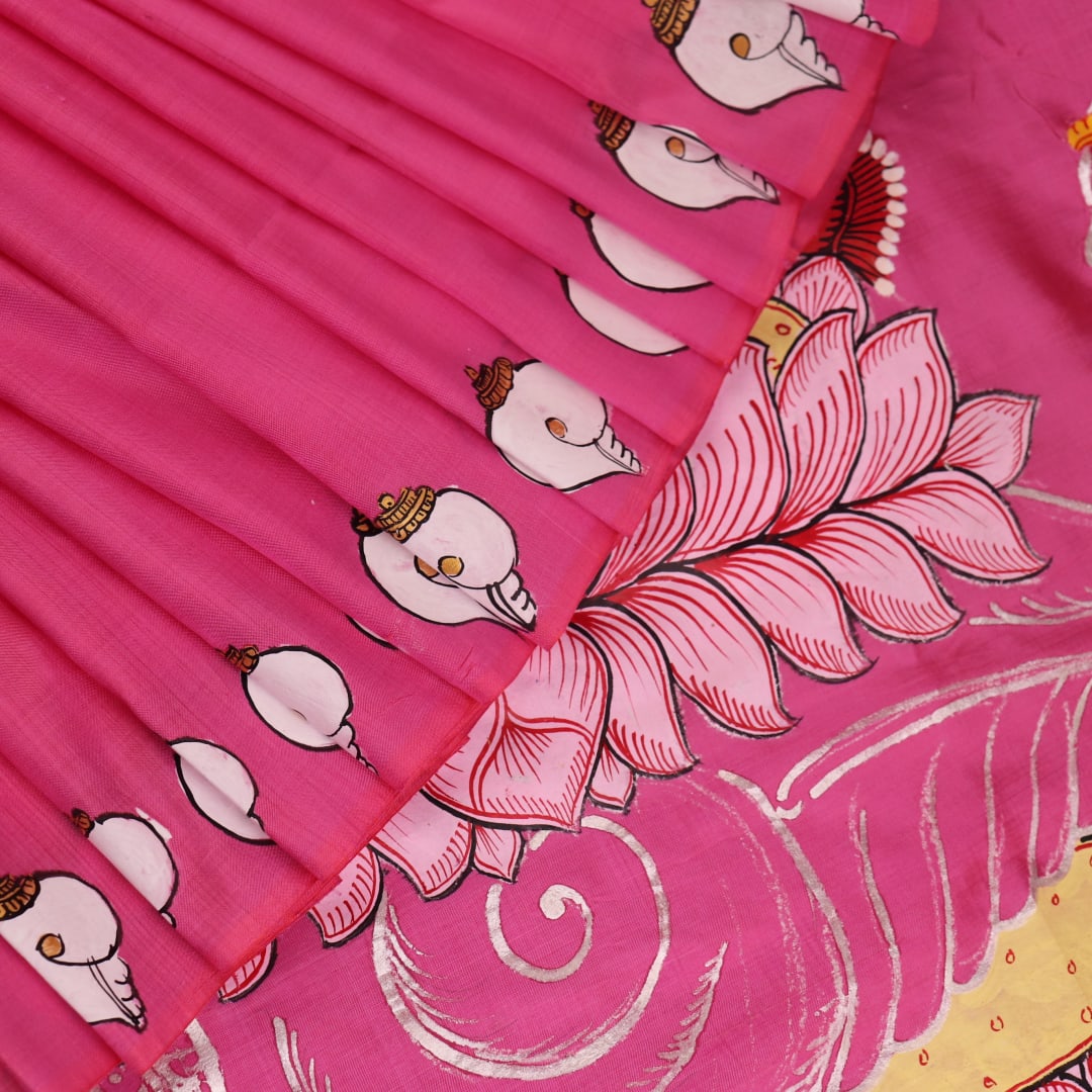 Close-up of pink silk Patachitra saree fabric, showcasing hand-painted texture and fine details.