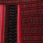 Model wearing a black and red Sambalpuri cotton saree, showing drape and overall style.