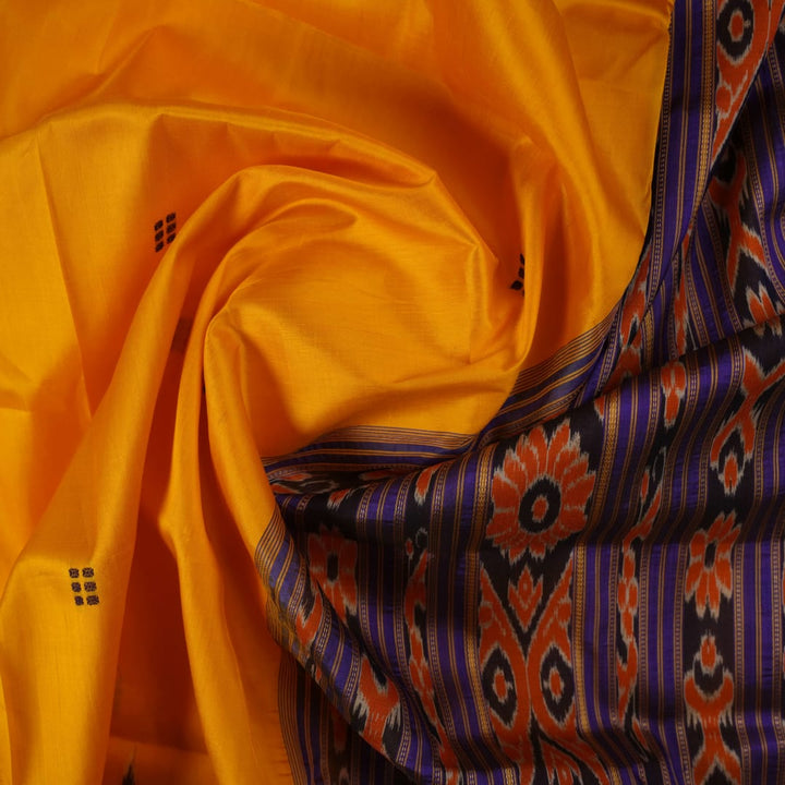 Full styling view of a model draped in a vibrant yellow and blue handloom Khandua silk saree with butta work.