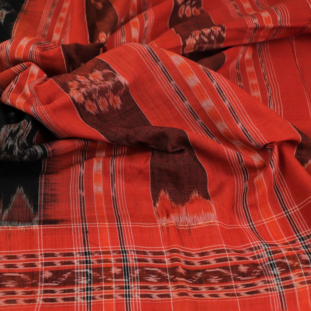 Black cotton Sambalpuri dupatta with rust motifs, styled on a mannequin