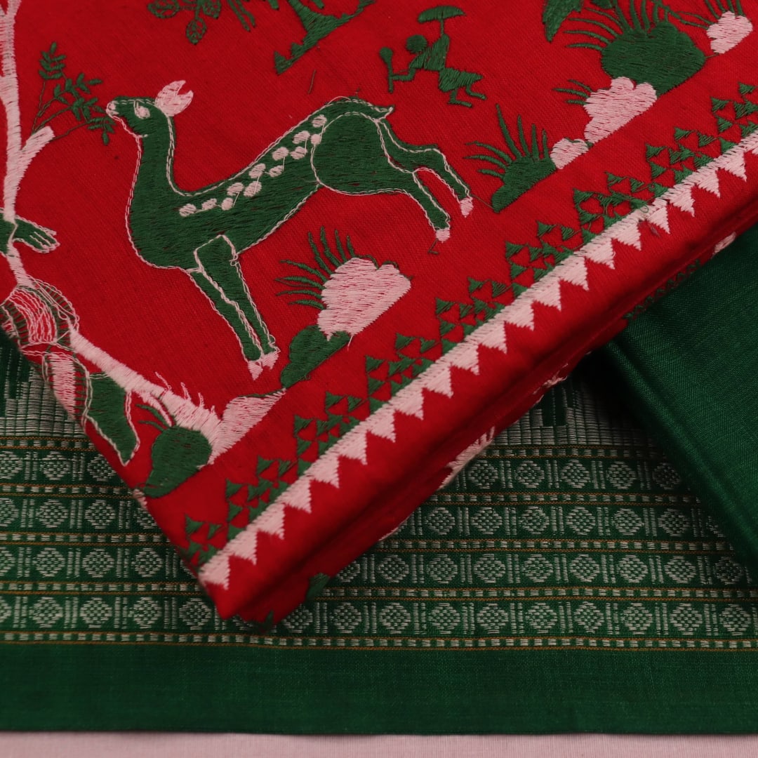 Red and green cotton Sambalpuri dress material with a doll pattern on the body of the fabric.