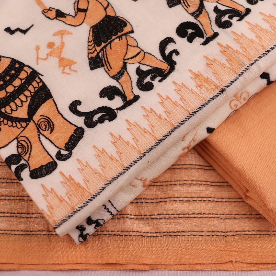 Detail of brown and white cotton Sambalpuri dress material with a doll pattern on a white background