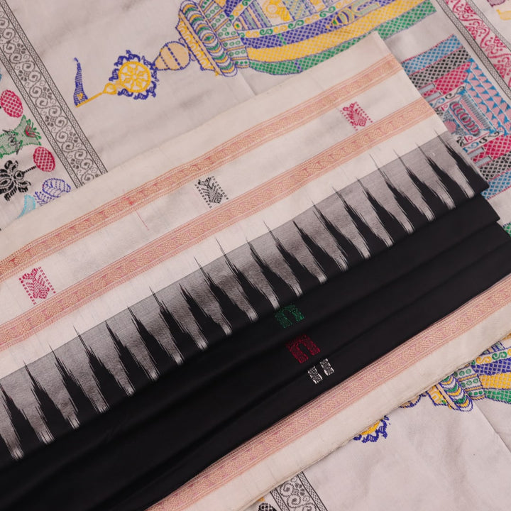Close-up texture of black and white Bomkai silk saree with butta pattern.