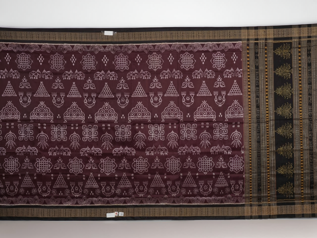 Micro close-up of the maroon Sambalpuri silk fabric, revealing its luxurious texture and handloom weave.