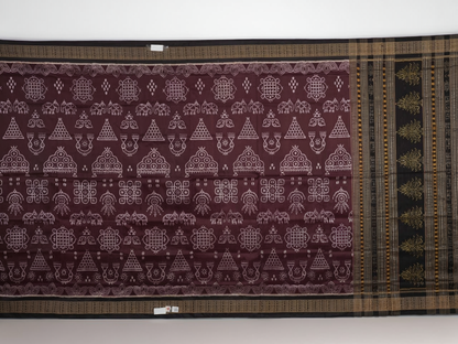 Micro close-up of the maroon Sambalpuri silk fabric, revealing its luxurious texture and handloom weave.