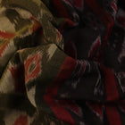 Green and black Sambalpuri cotton saree with motifs, elegantly draped for styling.