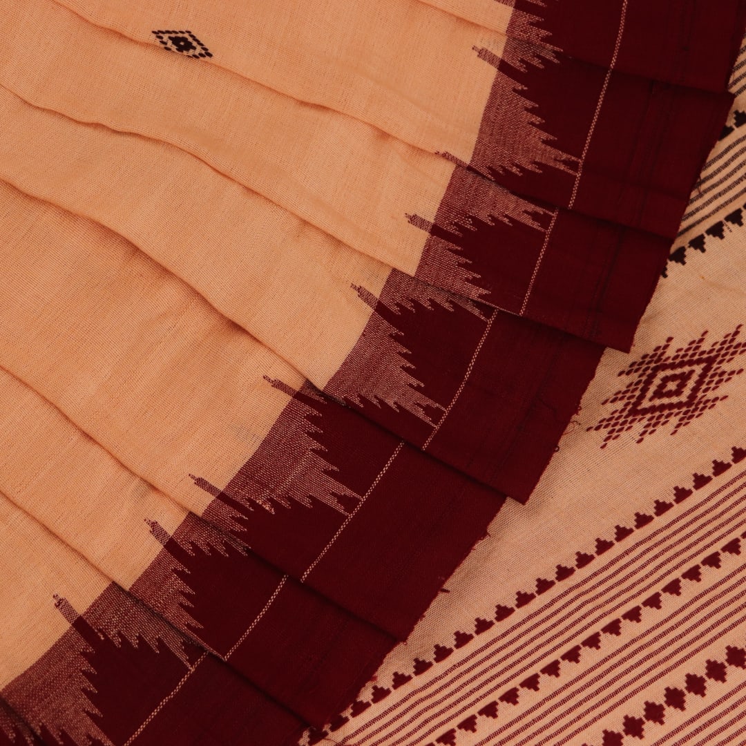 Full view of a cream-colored handloom Kotpad cotton saree with maroon butta patterns