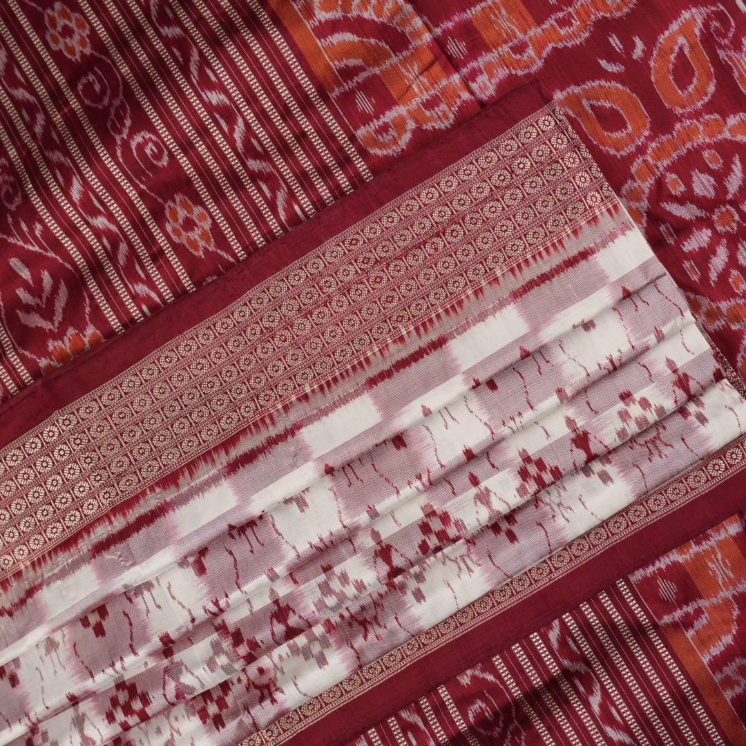 Close-up of the Sambalpuri silk saree fabric, detailing its luxurious texture and fine handloom weave.
