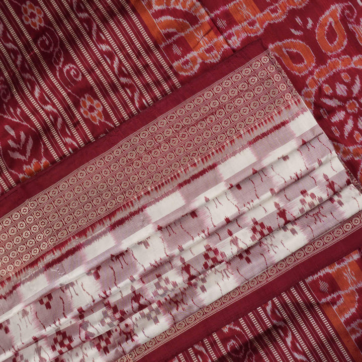 Close-up of the Sambalpuri silk saree fabric, detailing its luxurious texture and fine handloom weave.
