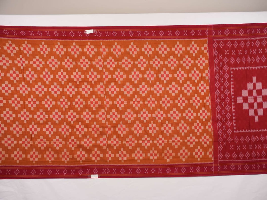 Full drape styling of a brown and maroon Sambalpuri cotton saree with motifs, modeled for elegant look.