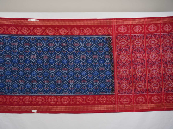 Full flat lay view of a blue and red Sambalpuri cotton saree showcasing the entire body and pallu design.