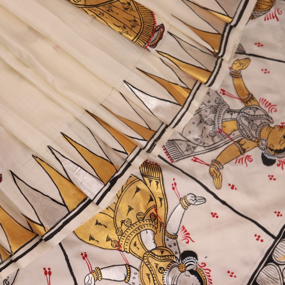 Close-up of white silk Patachitra saree, showcasing the handloom fabric's texture and subtle paint details.