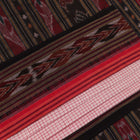 Woman draped in a white and black Sambalpuri cotton saree with motifs.